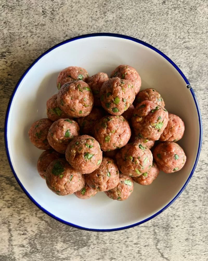 meatballs rolled on a white plate