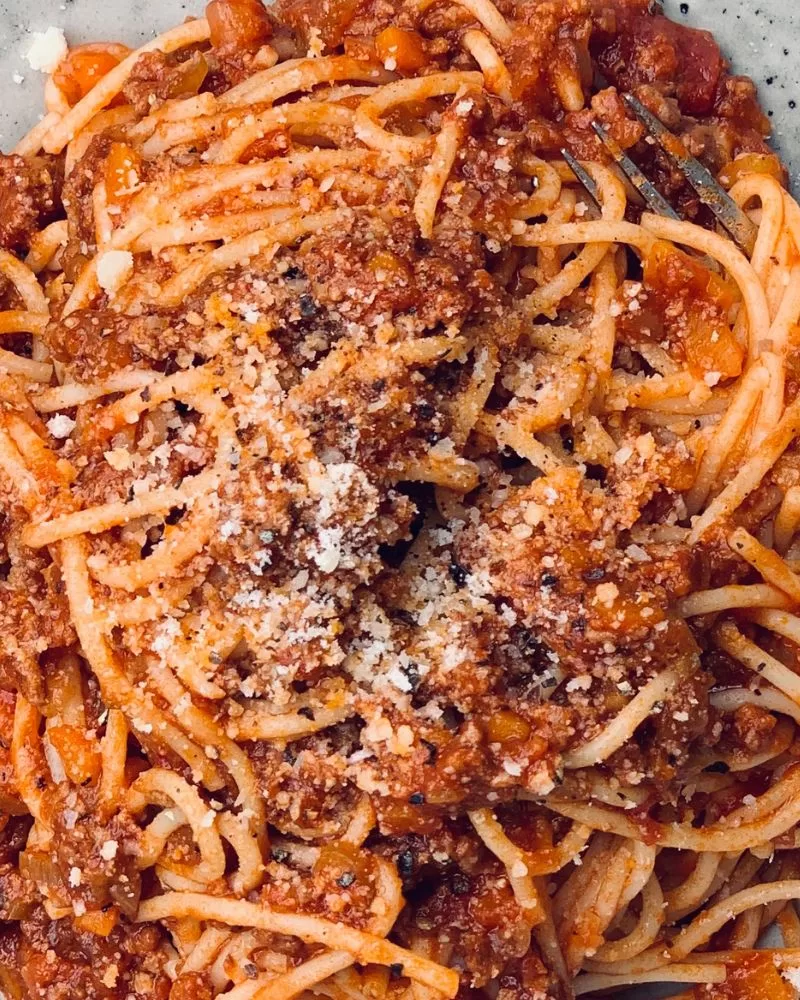 very close up of spaghetti in meat and tomato sauce