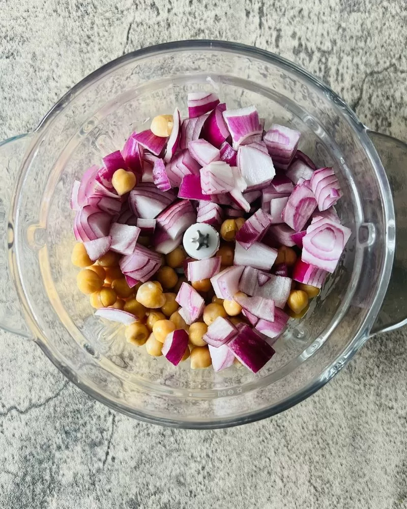 onion and chickpeas in a food processor bowl