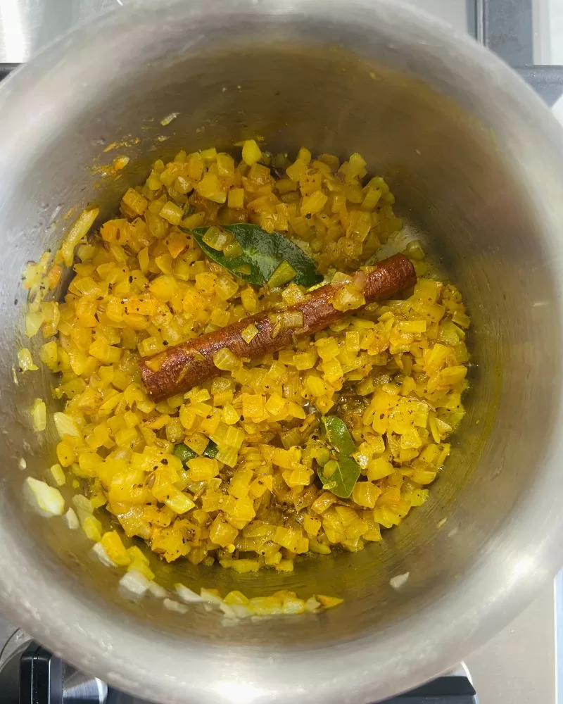 cooking onions with Indian spices in a saucepan