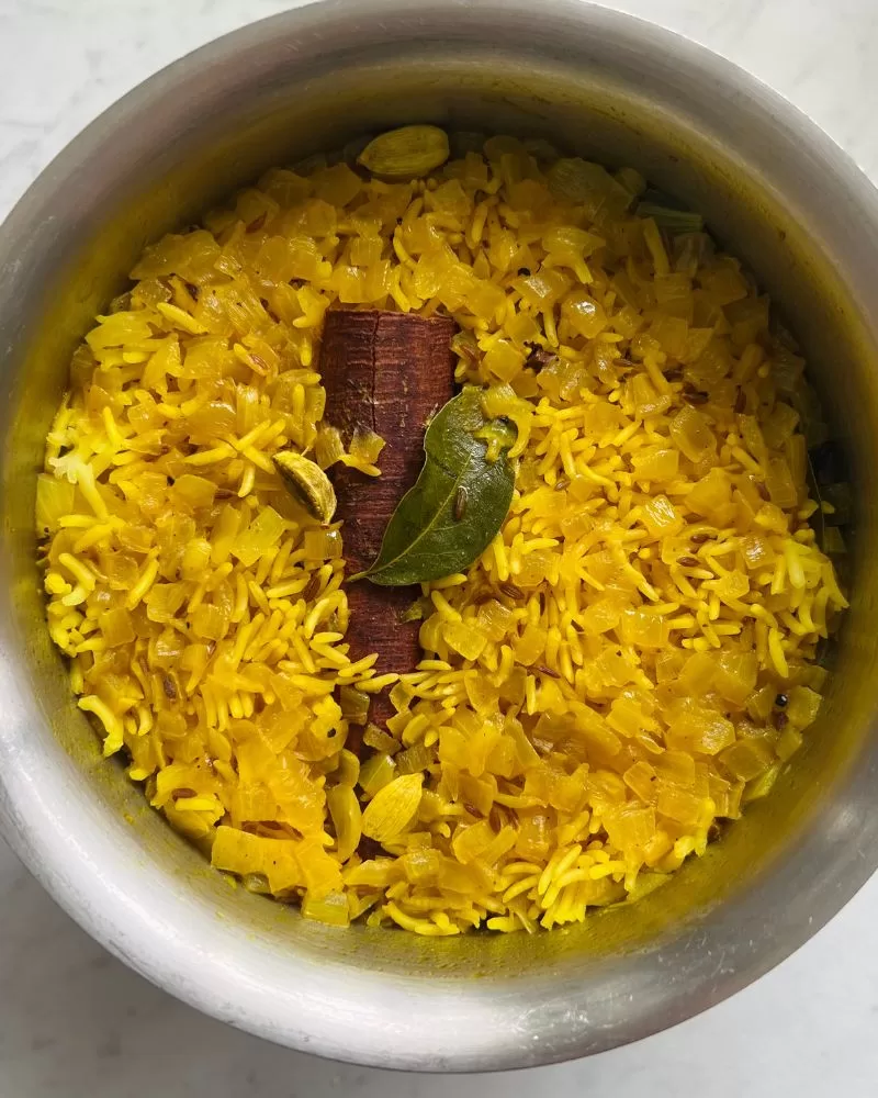 cooked yellow rice in saucepan