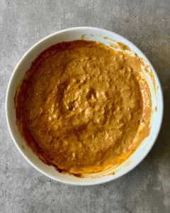 marinade in a white bowl on grey background