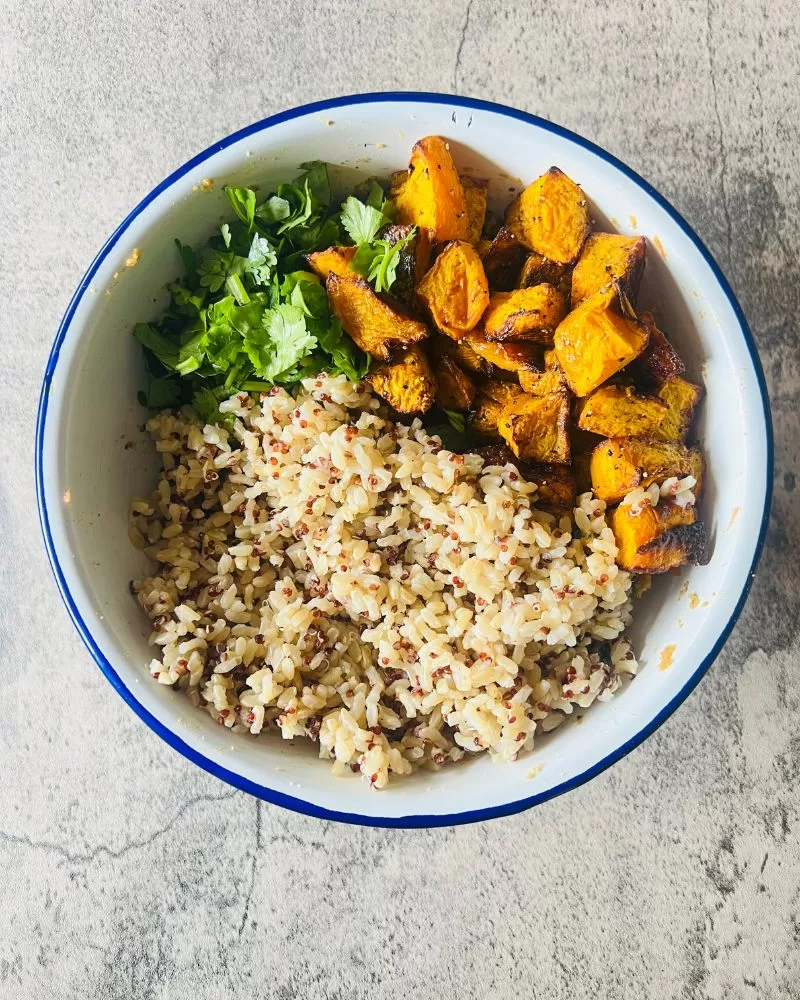 brown rice, coriander and diced pumpkin in a bowl