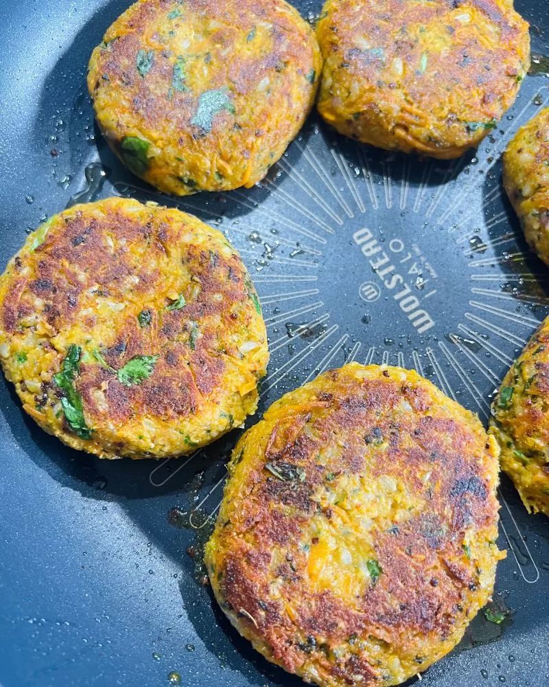 cooking veggie patties in a frying pan