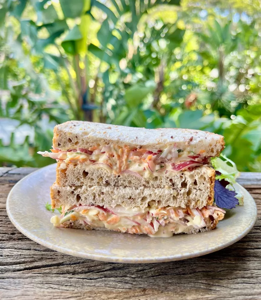 sandwich stacked on a plate with garden outlook