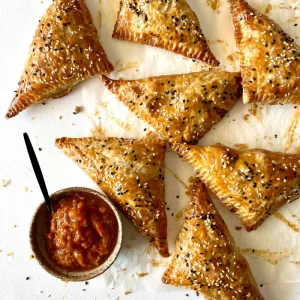 chicken spinach triangles on baking paper with chutney