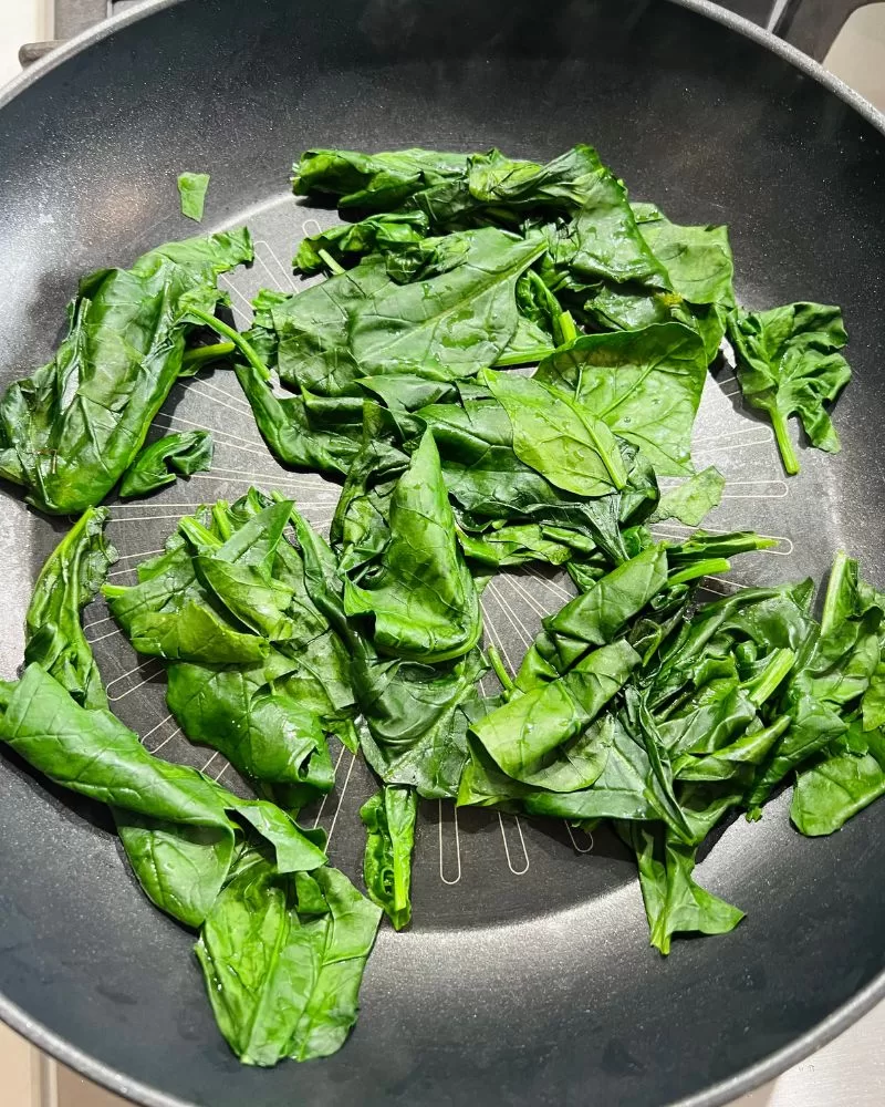 cooking spinach in pan