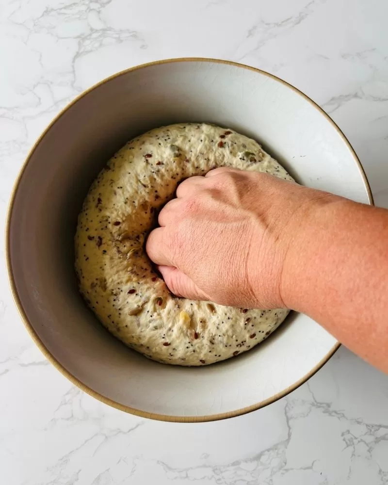 knocking dough back with fist