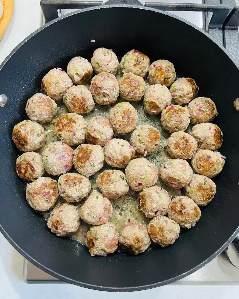 meatballs cooking in pan