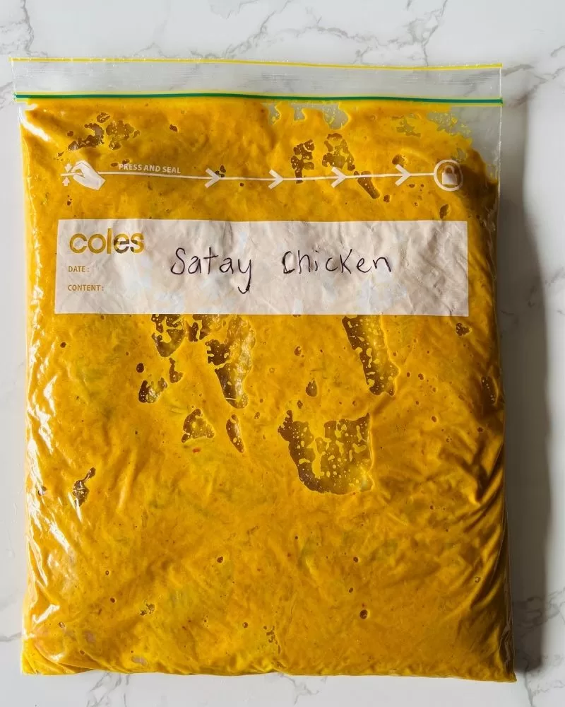 satay chicken marinating in a zip-lock bag