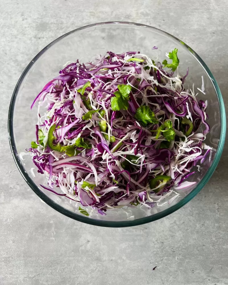 toss slaw in glass bowl