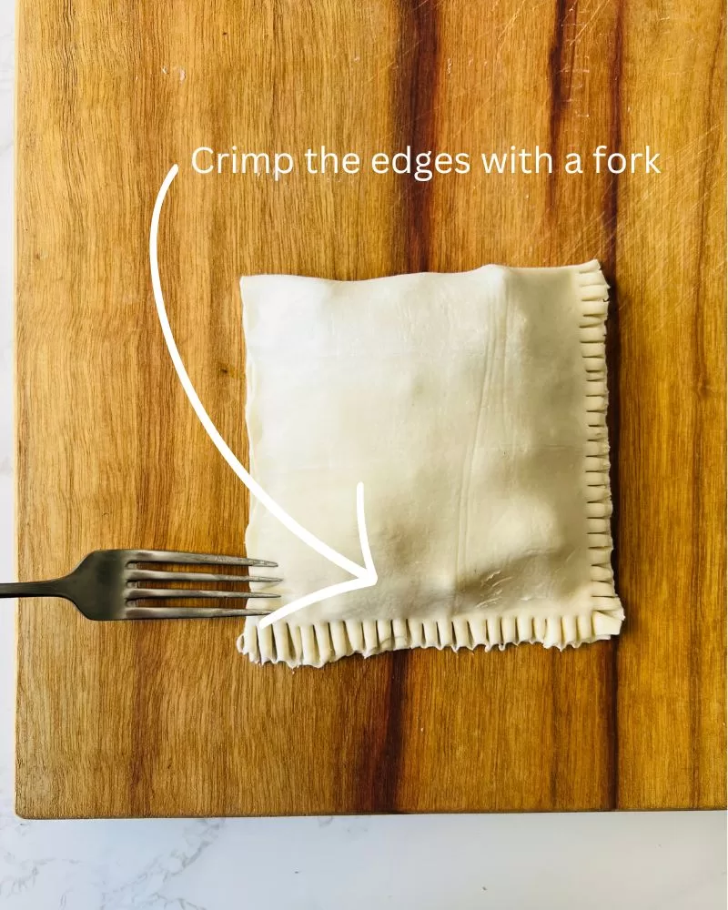crimping edge of pastry with a fork