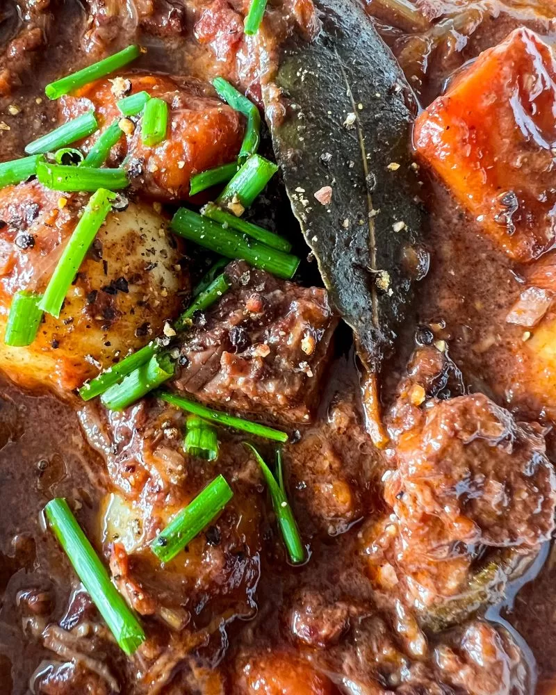 close up of beef in red wine