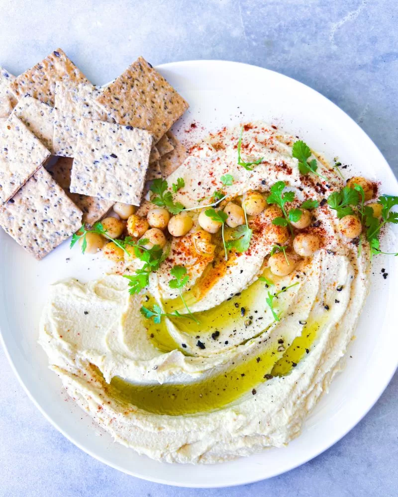 hummus on white plate with biscuits