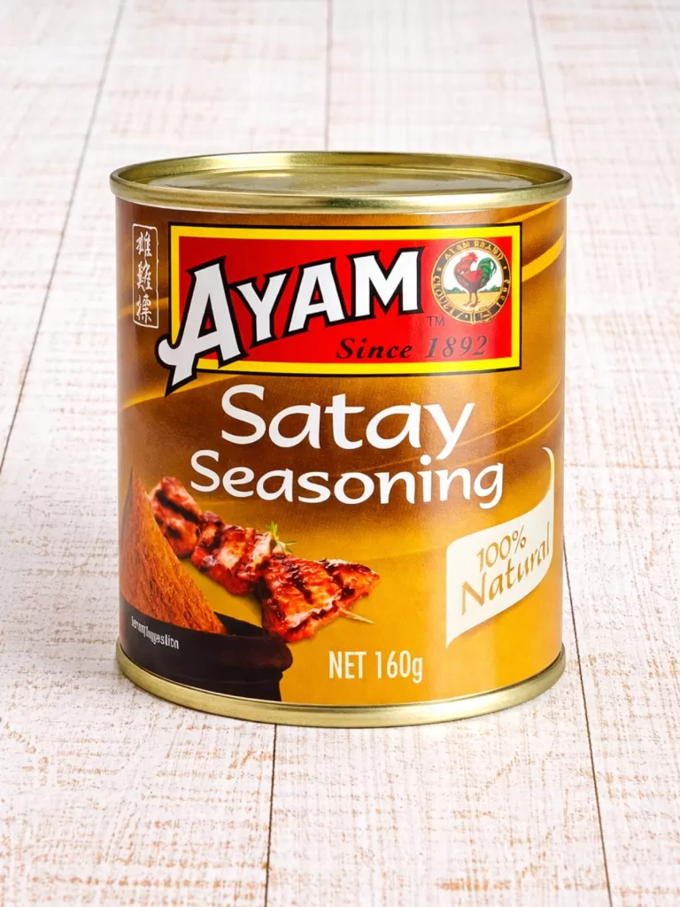 Can of Satay Seasoning on white rustic timber background.