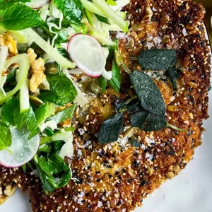 close up of chicken schnitzel with salad