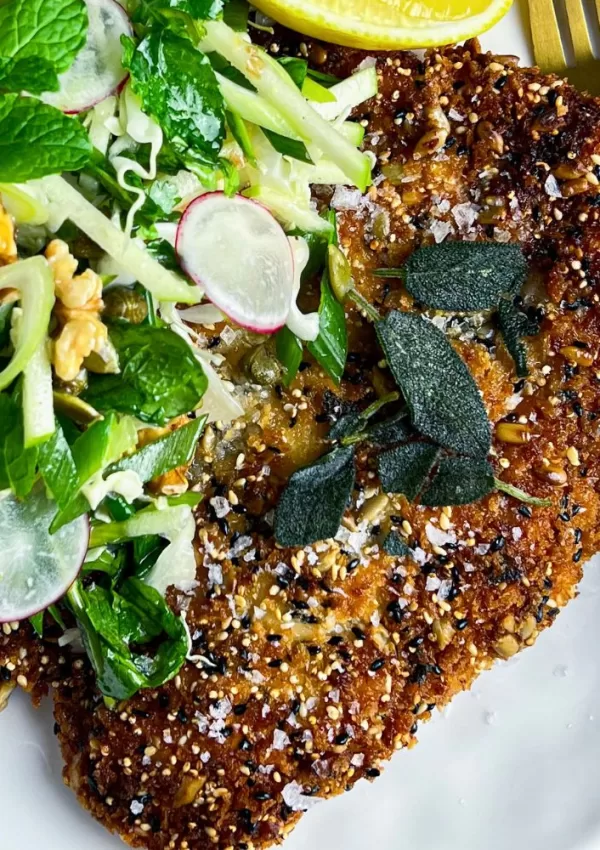 close up of chicken schnitzel with salad