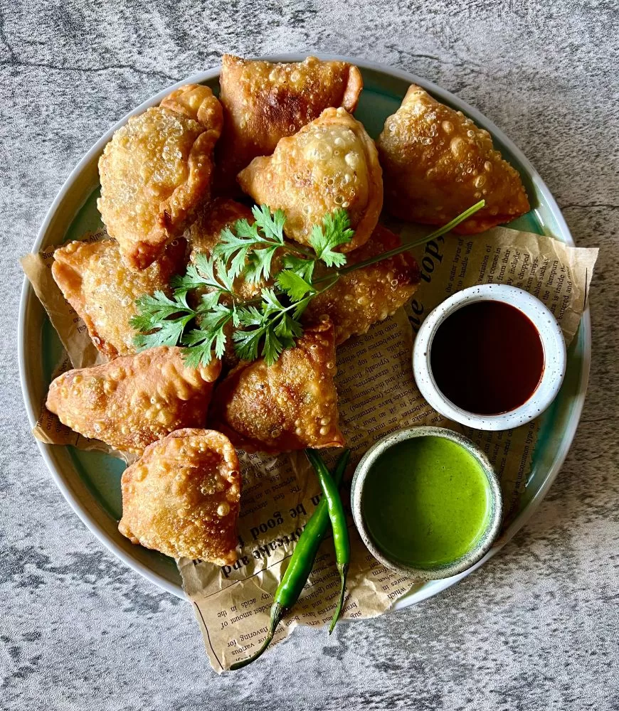 samosas on plate with dipping sauces