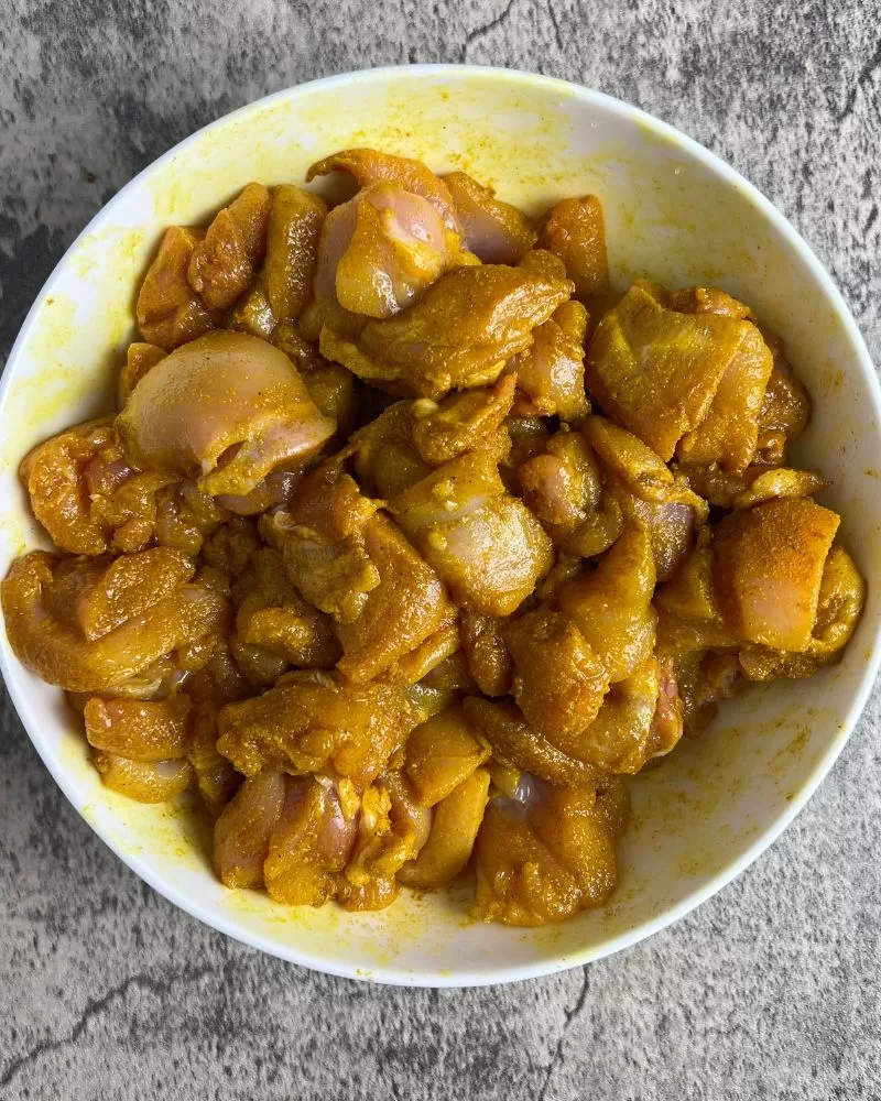 marinated chicken in white bowl