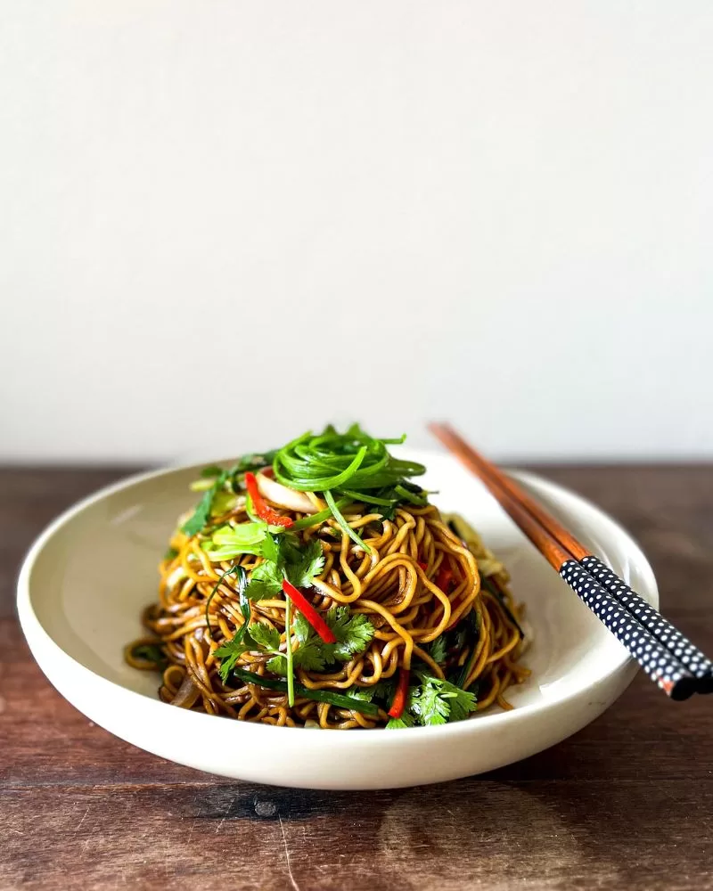 soy sauce noodles in a bowl with chopsticks