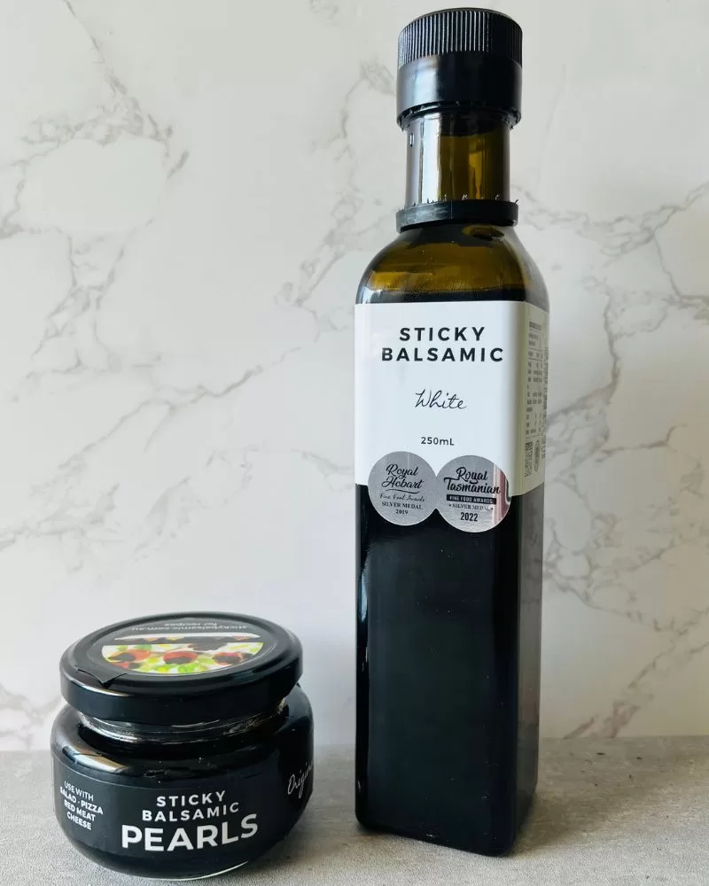 bottle of sticky balsamic and small jar of sticky balsamic pearls