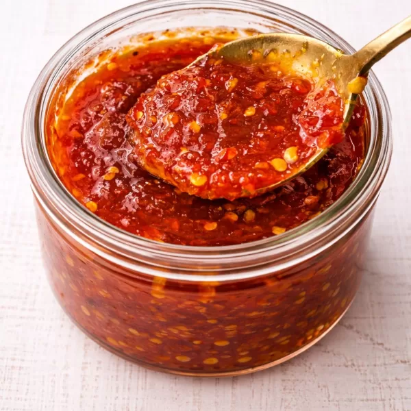 chilli jam in glass jar with spoon