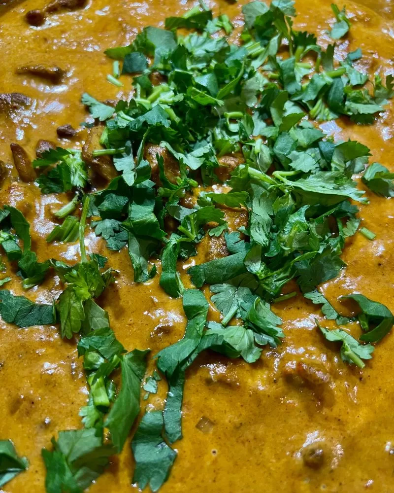 curry in pan with herbs