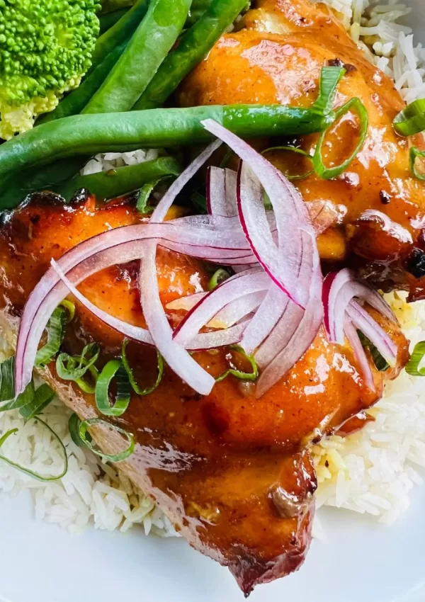 sticky chicken with sliced onions, green beans on rice