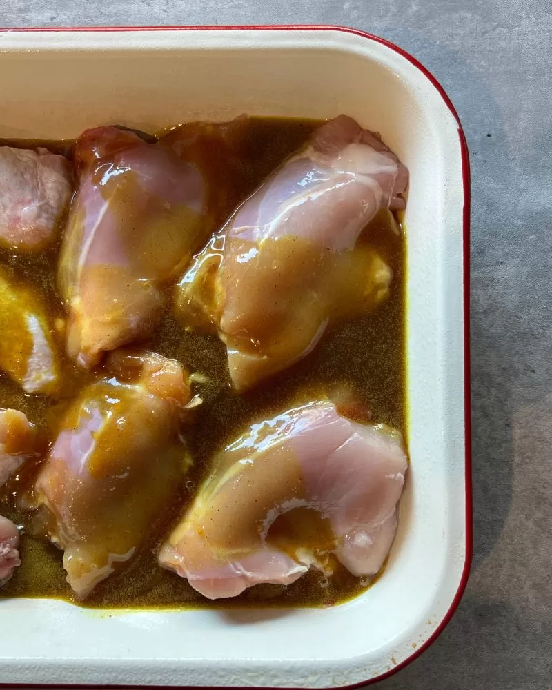 curried honey chicken with curry sauce in baking dish