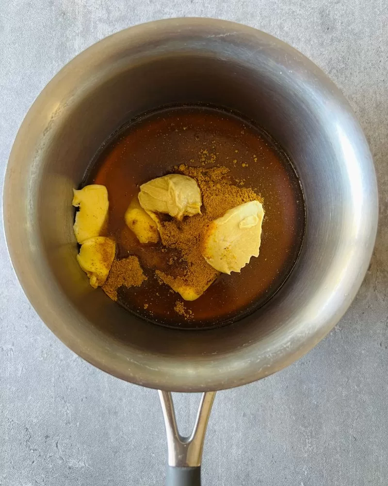 ingredients in a saucepan for honey butter curry sauce