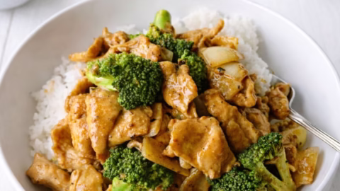 Satay chicken stir fry with Jimmy’s saté sauce served over rice with broccoli