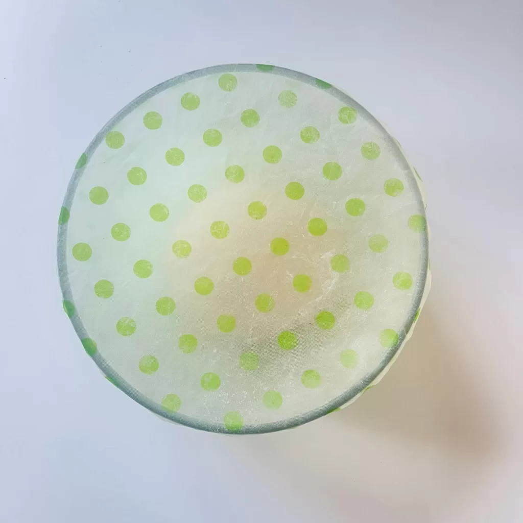 A bowl covered with a reusable food wrap while the flatbread dough rests.