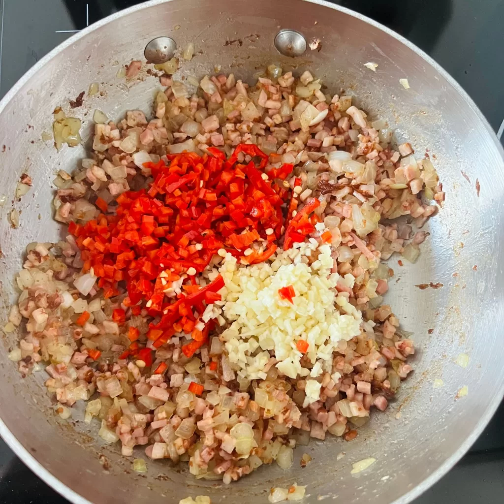 Fresh garlic and chilli added to the bacon and onion mixture for tomato bacon and chilli jam
